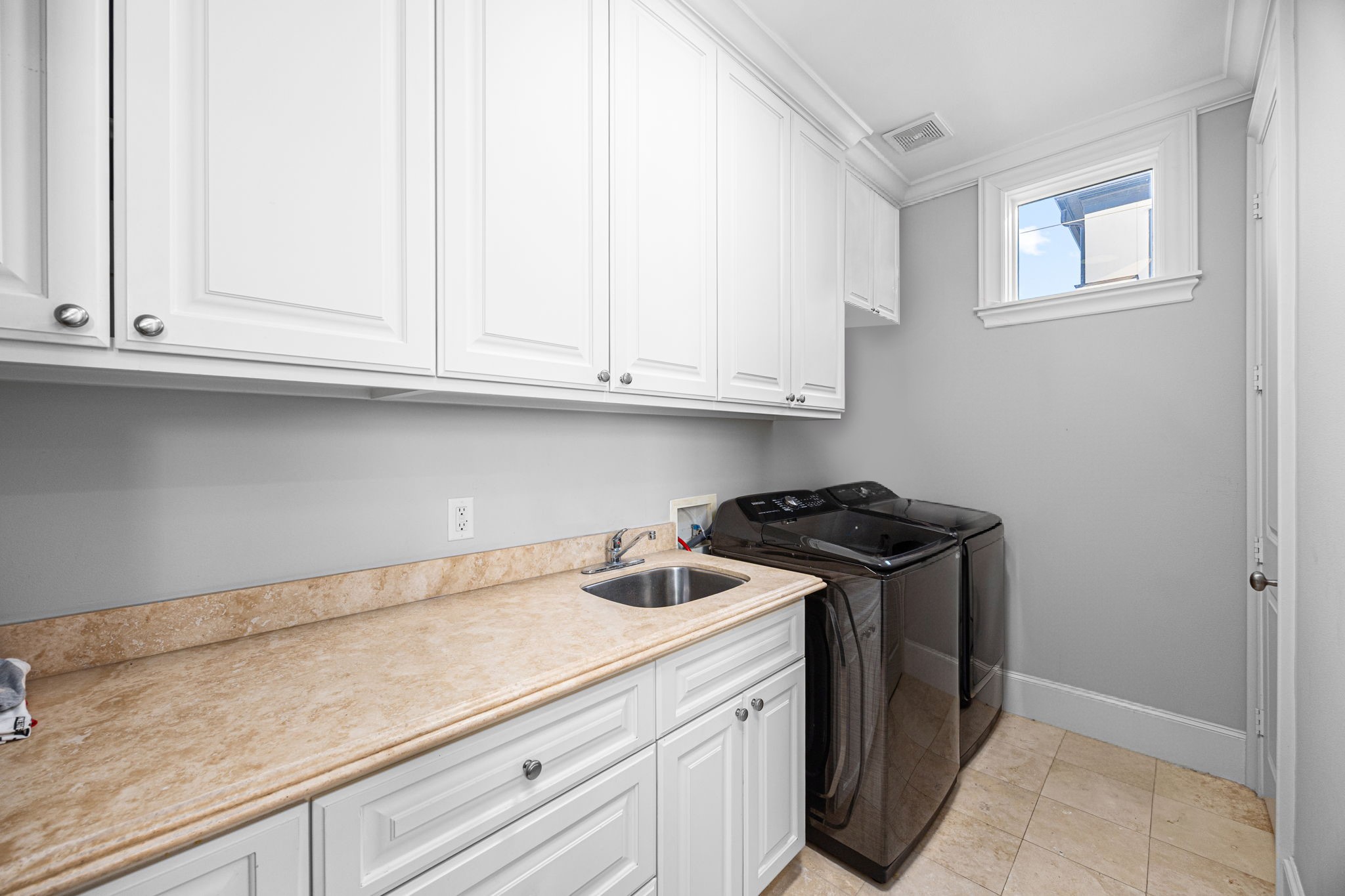 1723 Sunset Boulevard Houston, TX 77005 - Photo 32 of 50 The conveniently located laundry room near the primary suite features built-in cabinetry and workspace designed to simplify everyday living. There is a closet for storage needs.