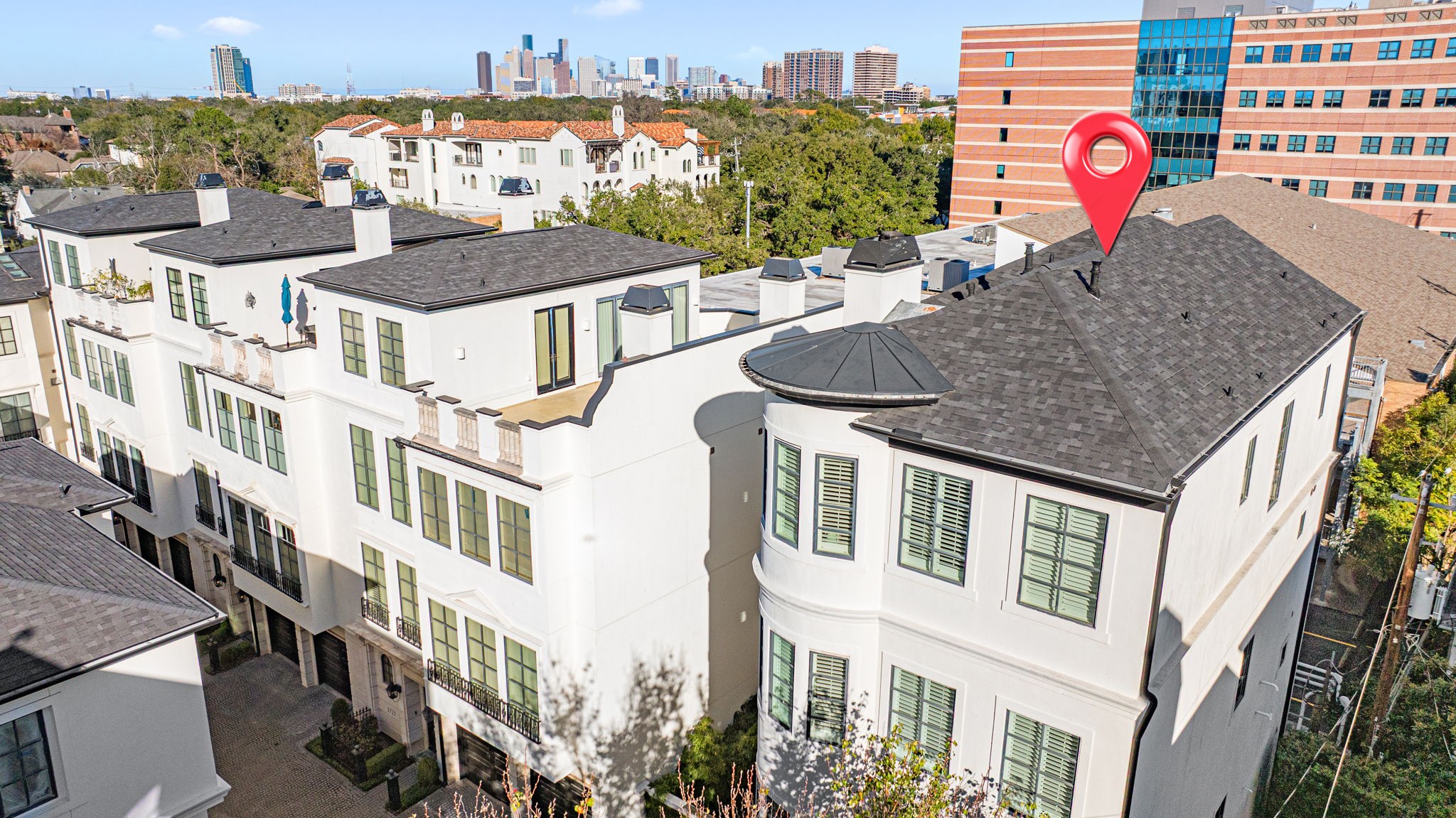 1723 Sunset Boulevard Houston, TX 77005 - Photo 44 of 50 An aerial view highlights the townhome’s free-standing presence. This is one of only two free-standing units in the gated neighborhood. In the distance you see views of Downtown Houston, which are viewable from your 4th floor outdoor patio.