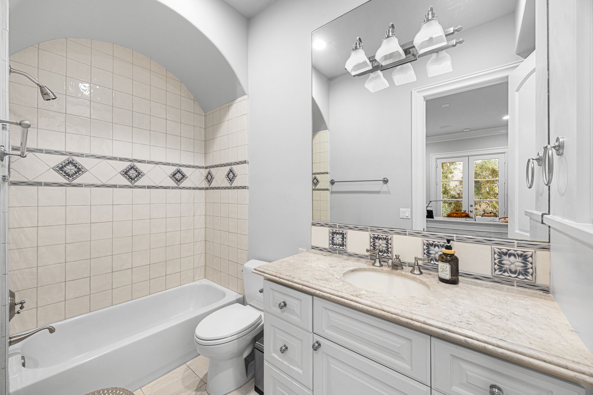 1723 Sunset Boulevard Houston, TX 77005 - Photo 7 of 50 The first-floor full bathroom is thoughtfully designed with classic tilework, quality finishes, and timeless style for everyday comfort. It also has a walk-in closet just to the right as you walk in.