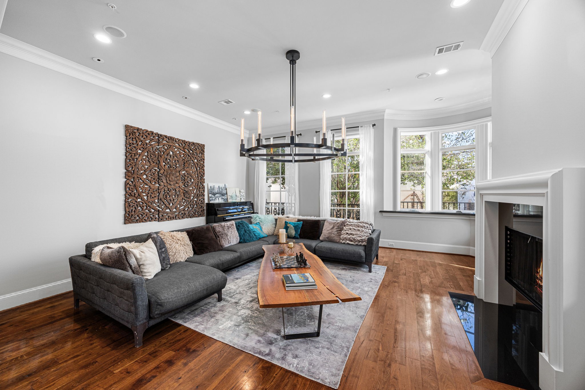 1723 Sunset Boulevard Houston, TX 77005 - Photo 10 of 50 Sunlight pours into the living space through expansive windows, highlighting refined architectural details and a seamless flow into the surrounding rooms. This photo has been virtually staged.