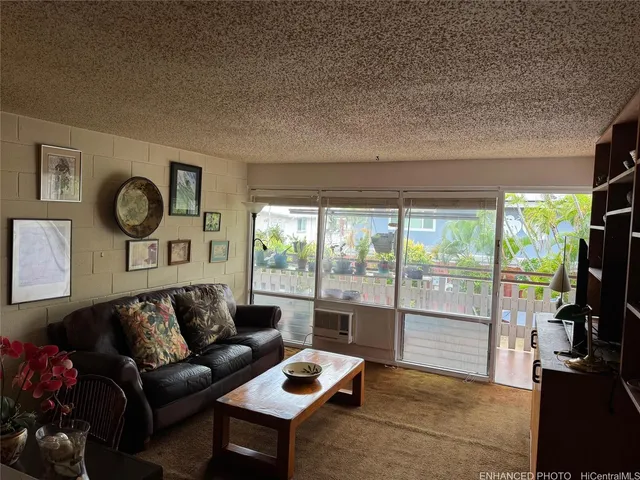 a living room with furniture a flat screen tv and a large window