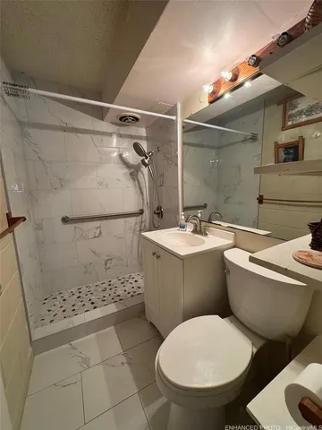 a bathroom with a toilet sink and shower
