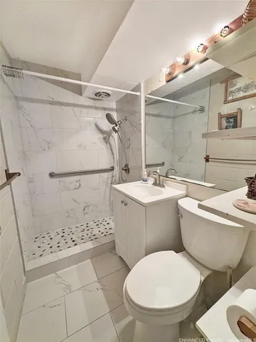 a bathroom with a toilet sink and shower