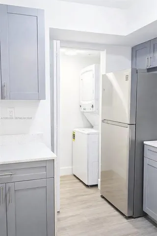 a utility room with cabinets washer and dryer