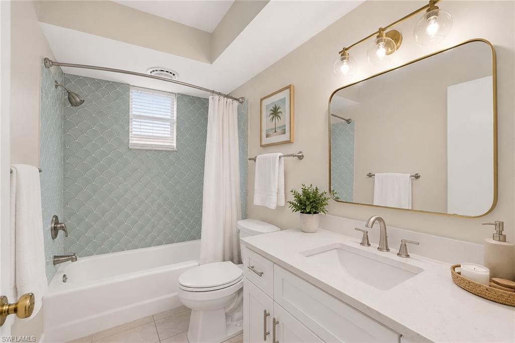 5290 Cypress Lane Naples, FL 34113 - Photo 24 of 39 a bathroom with a sink a toilet and a mirror