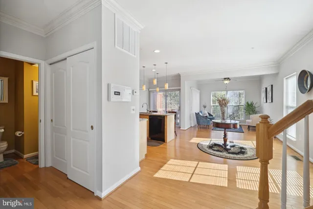 a living room with furniture a rug and kitchen view