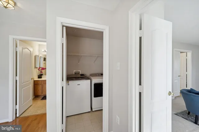 a kitchen with a refrigerator and table