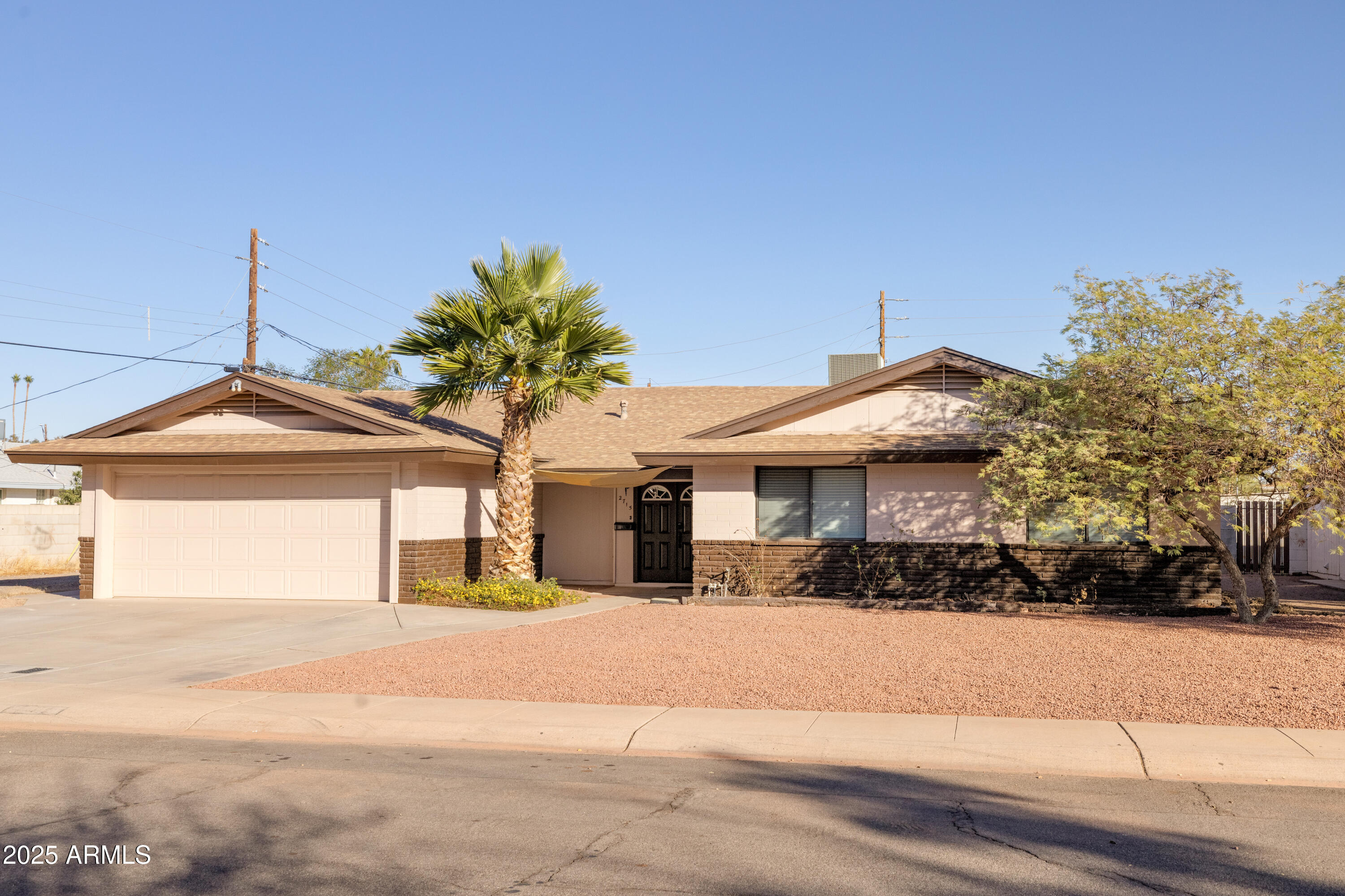 2715 South Rita Lane Tempe, AZ 85282 - Photo 1 of 30 a front view of a house with a yard and garage