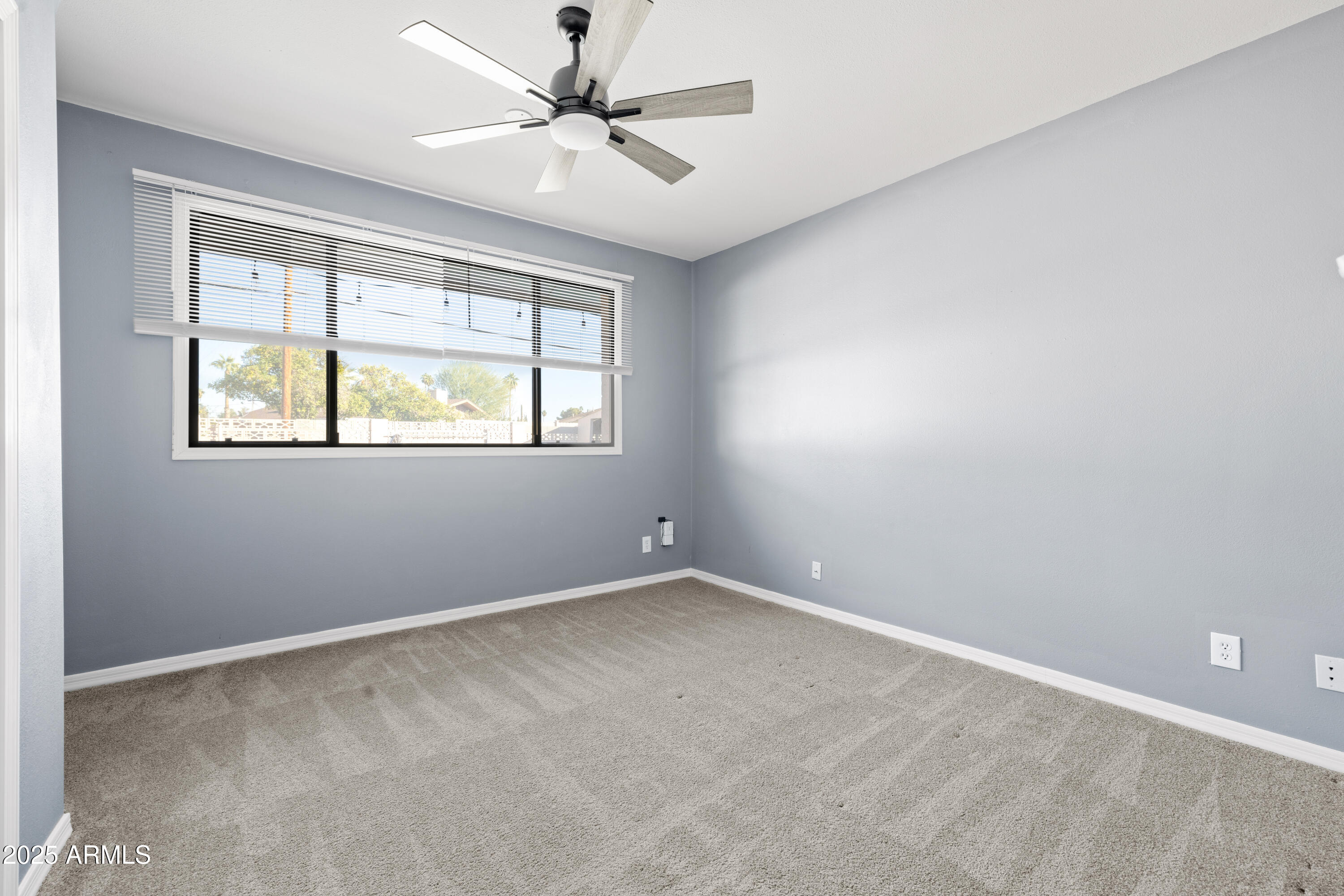 2715 South Rita Lane Tempe, AZ 85282 - Photo 15 of 30 an empty room with a window and a fan