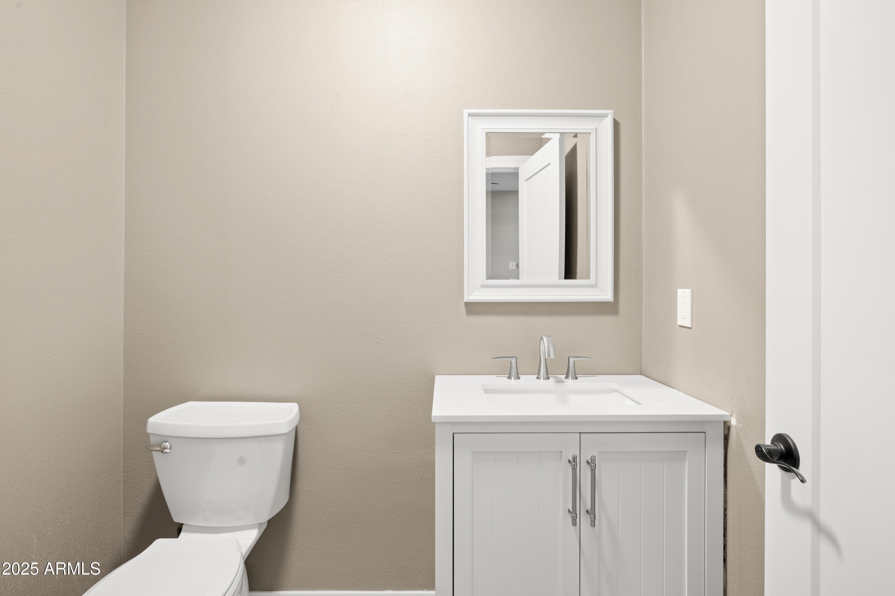 2715 South Rita Lane Tempe, AZ 85282 - Photo 17 of 30 a bathroom with a toilet sink and mirror