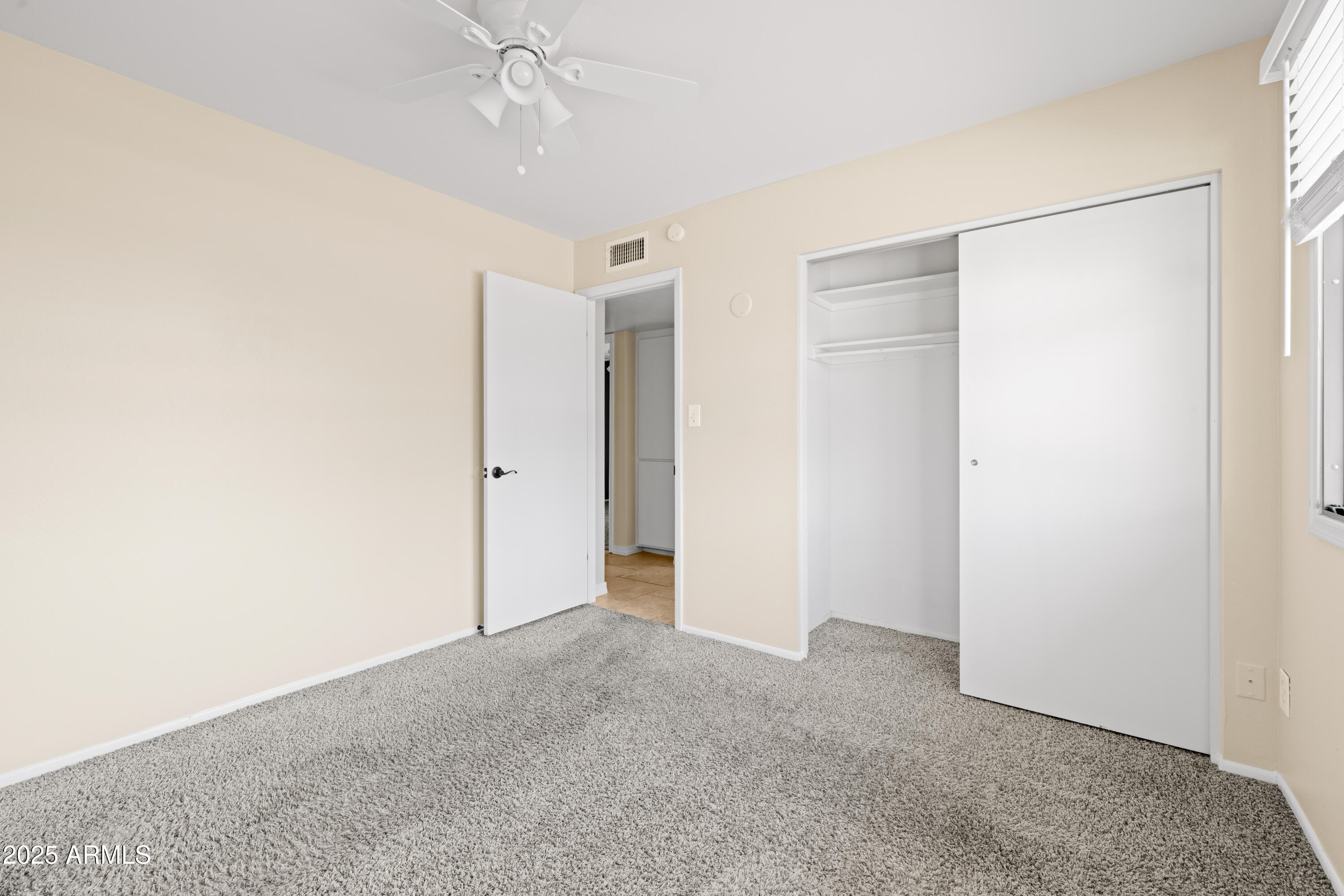 2715 South Rita Lane Tempe, AZ 85282 - Photo 23 of 30 a view of an empty room with a ceiling fan