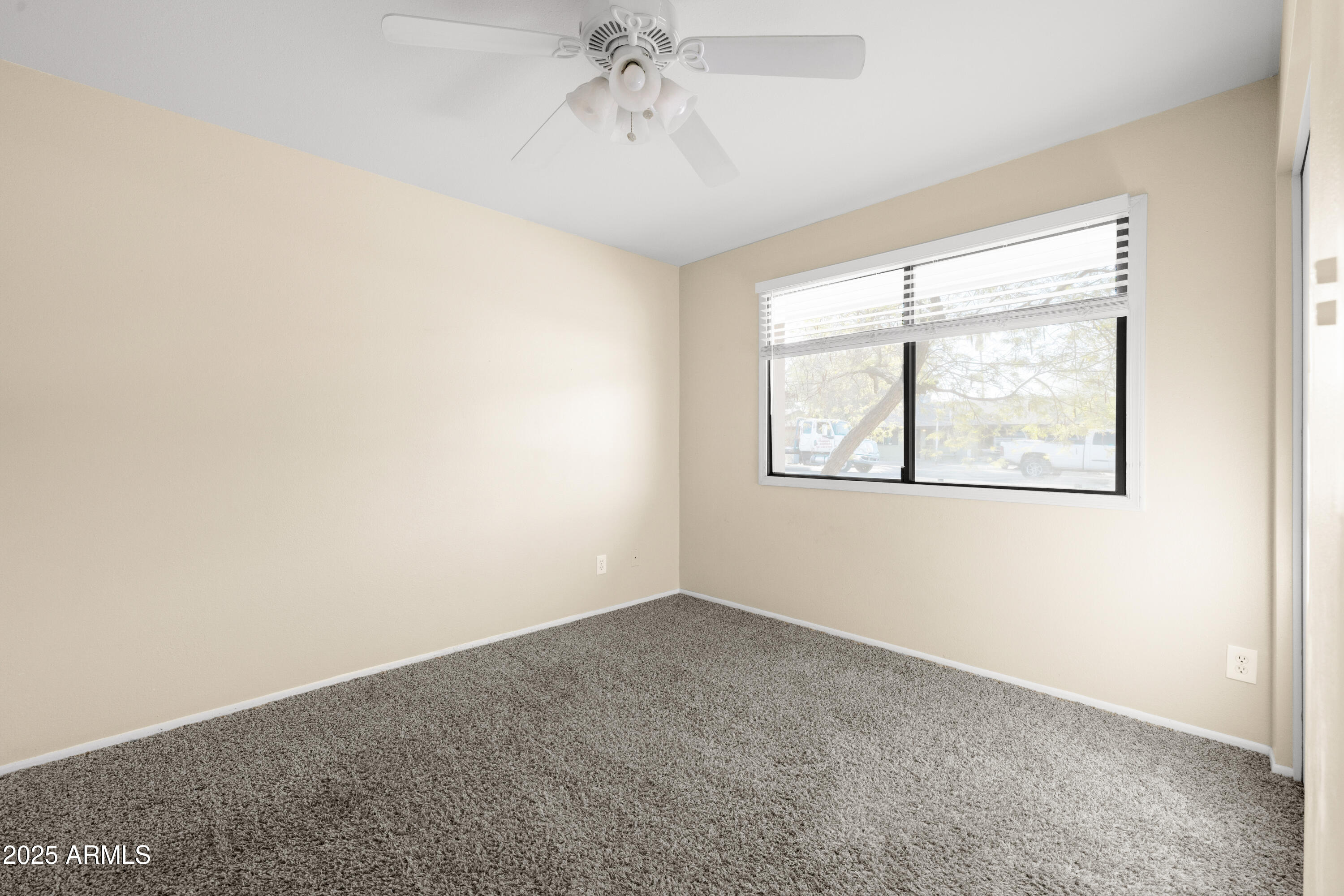 2715 South Rita Lane Tempe, AZ 85282 - Photo 24 of 30 an empty room with windows and chandelier fan
