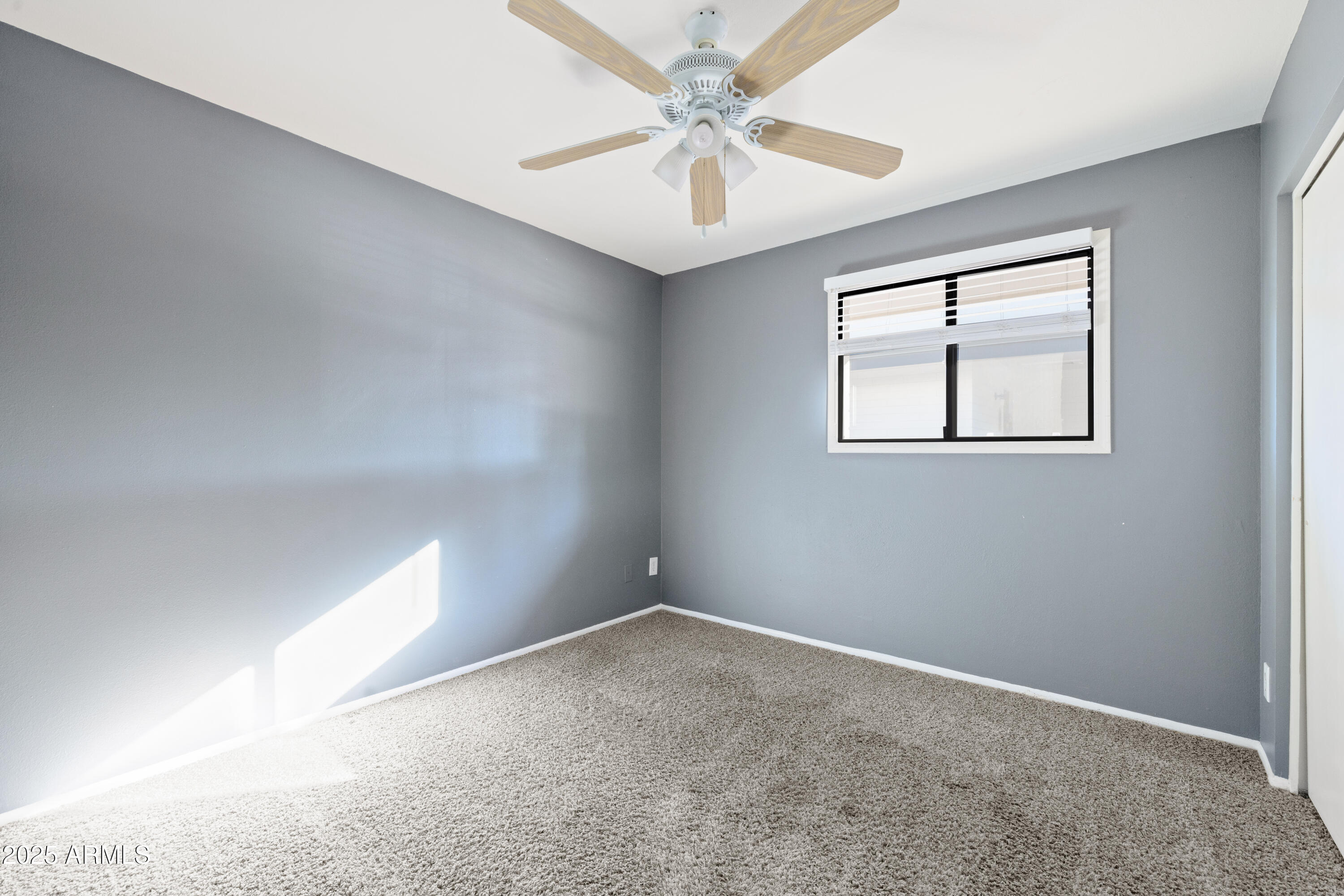 2715 South Rita Lane Tempe, AZ 85282 - Photo 26 of 30 an empty room with windows and fan