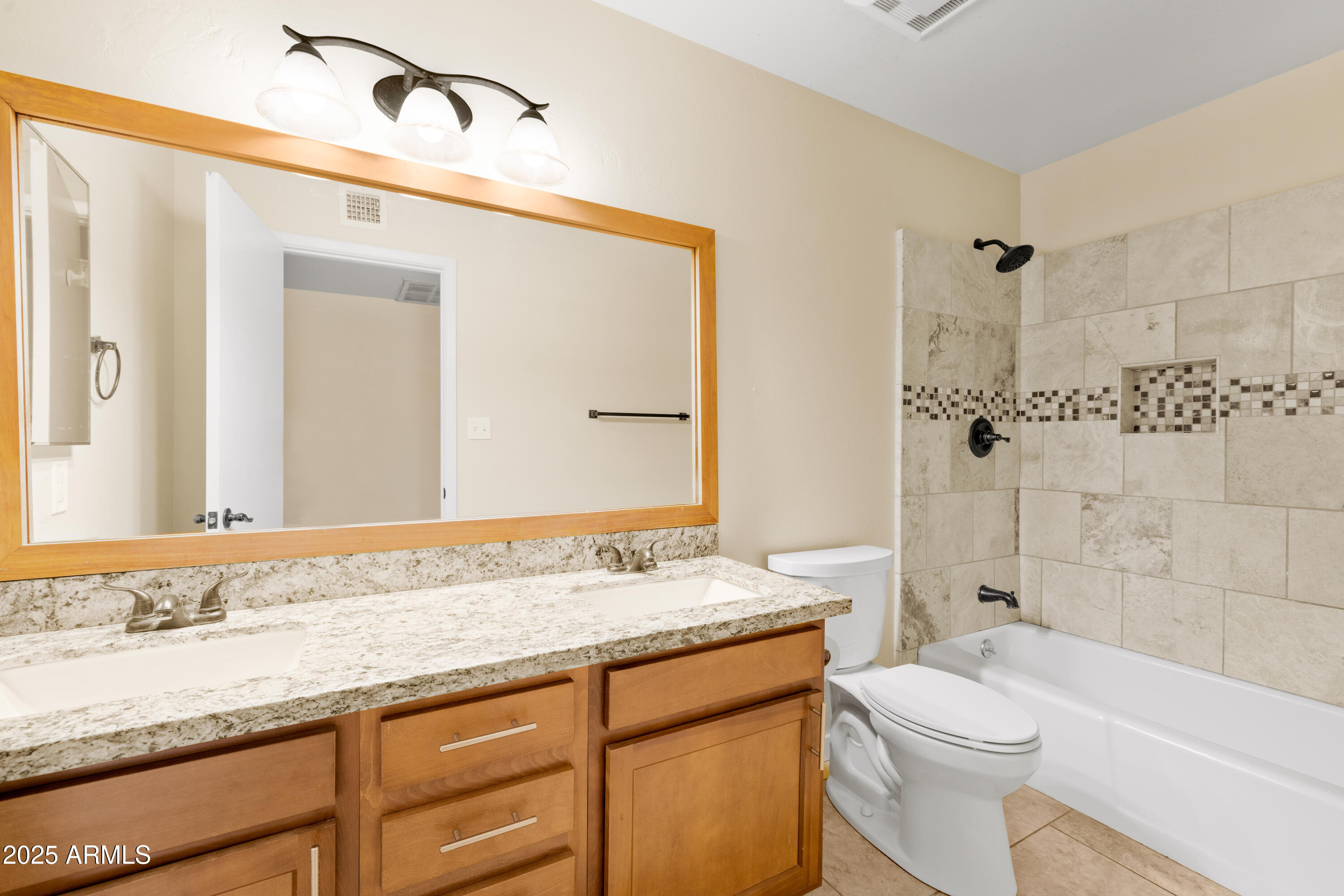 2715 South Rita Lane Tempe, AZ 85282 - Photo 28 of 30 a bathroom with a granite countertop sink a toilet and shower