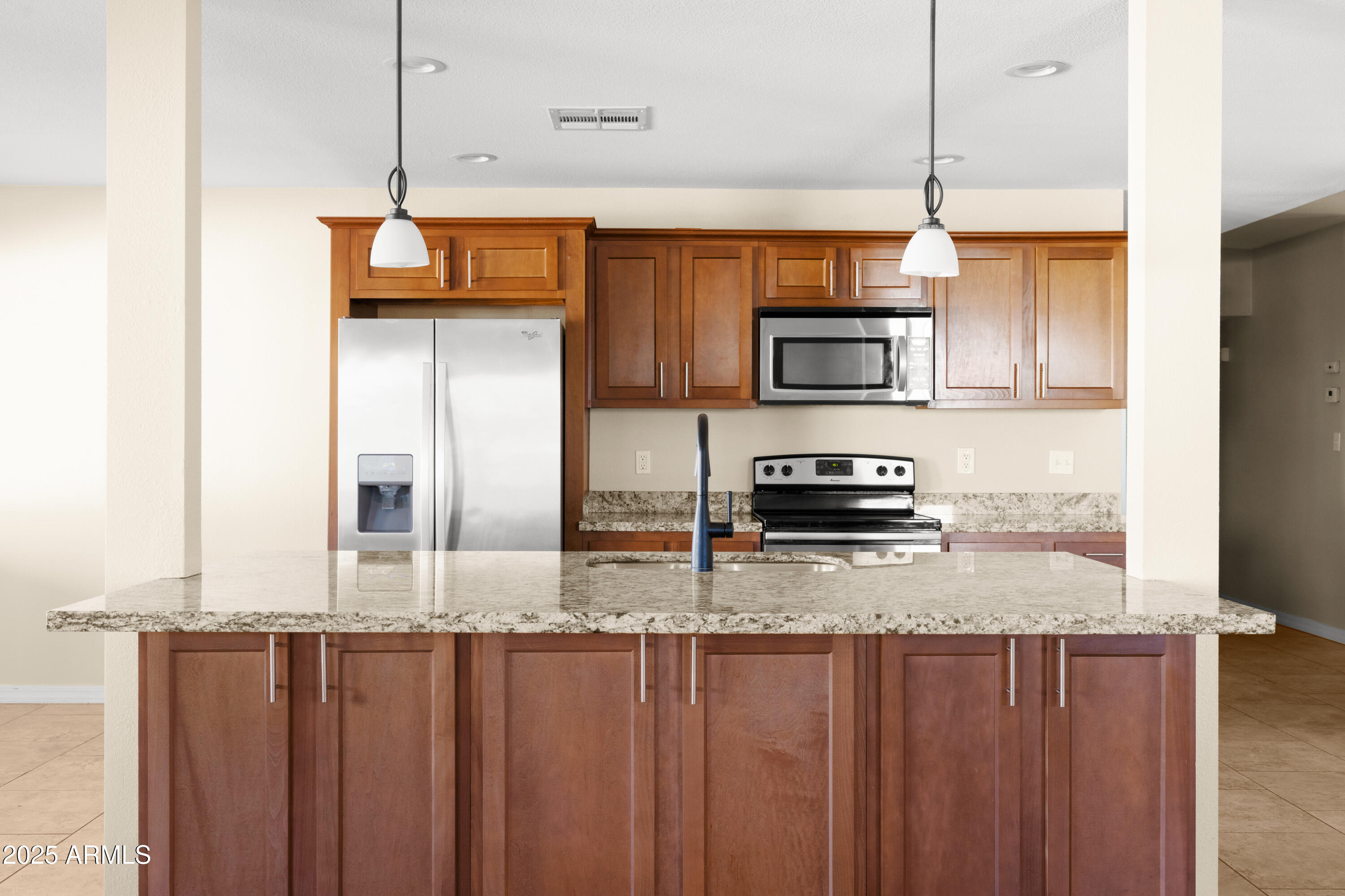 2715 South Rita Lane Tempe, AZ 85282 - Photo 6 of 30 a kitchen with stainless steel appliances granite countertop a refrigerator a stove and a sink with wooden floor