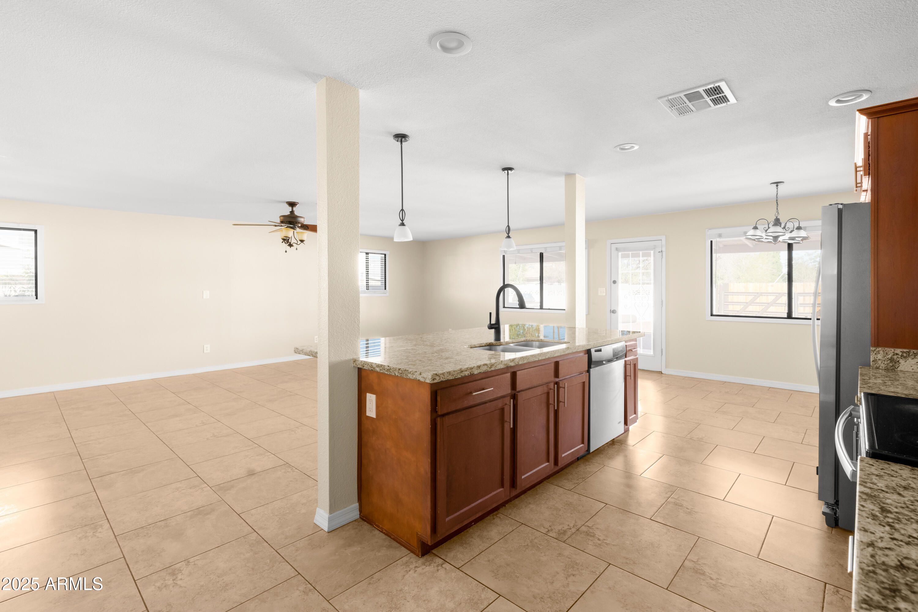 2715 South Rita Lane Tempe, AZ 85282 - Photo 8 of 30 a kitchen with stainless steel appliances granite countertop a sink and a stove
