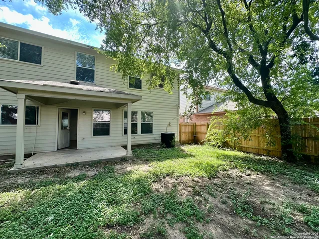 a view of a house with yard and sitting area