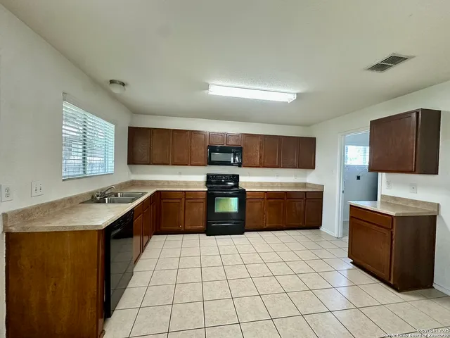 a kitchen with stainless steel appliances a sink and a stove