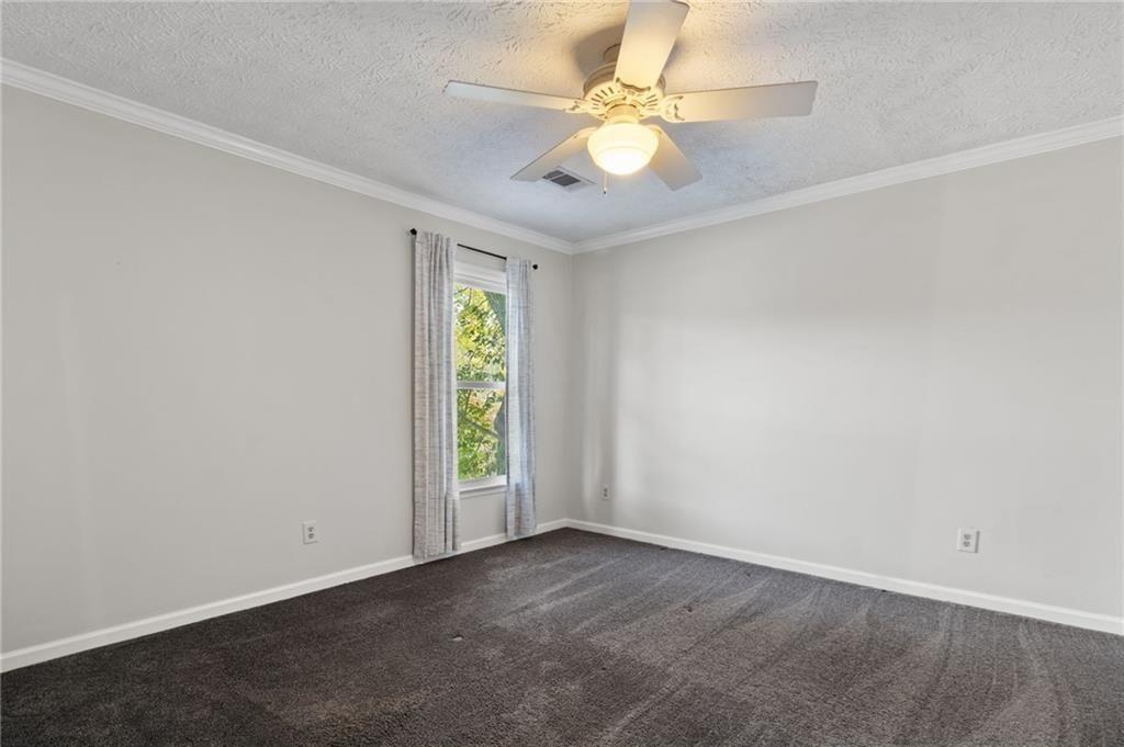 650 Corbin Lake Court Atlanta, GA 30350 - Photo 21 of 42 an empty room with windows and fan