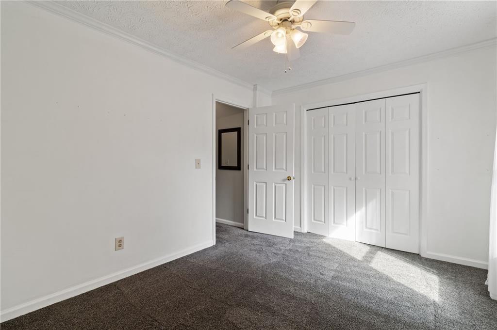 650 Corbin Lake Court Atlanta, GA 30350 - Photo 24 of 42 an empty room with a ceiling fan and a window
