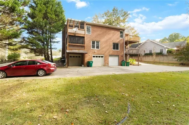 a yellow house sitting in middle of a yard