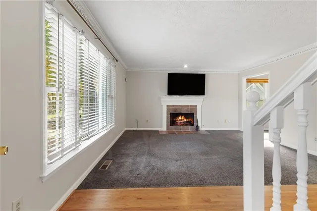 a view of empty room with fireplace and fan