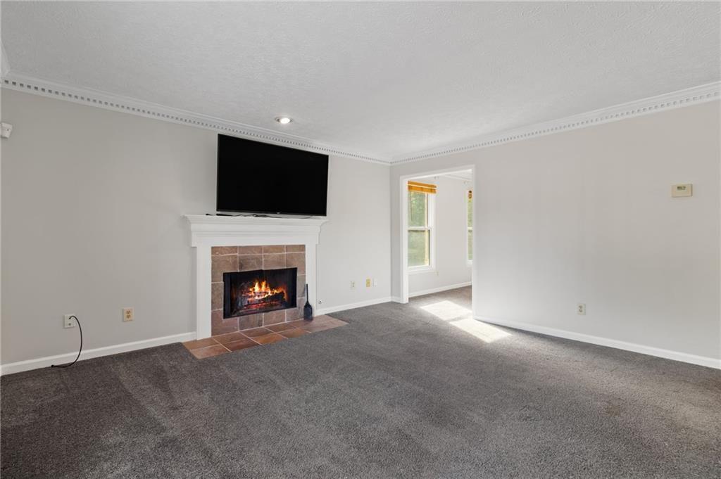 650 Corbin Lake Court Atlanta, GA 30350 - Photo 8 of 42 a view of a livingroom with a fireplace and a flat screen tv