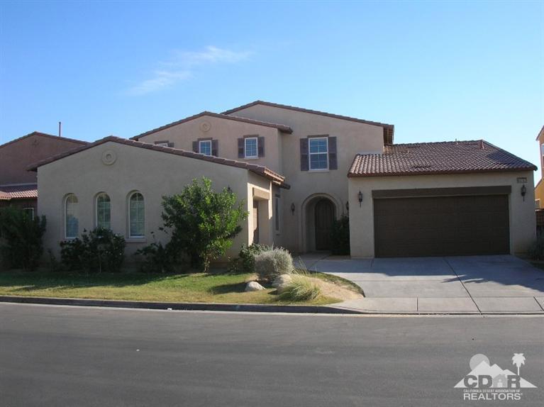82797 Mount Riley Drive Indio, CA 92203 - Photo 1 of 17 a house that has a large tree in front of it