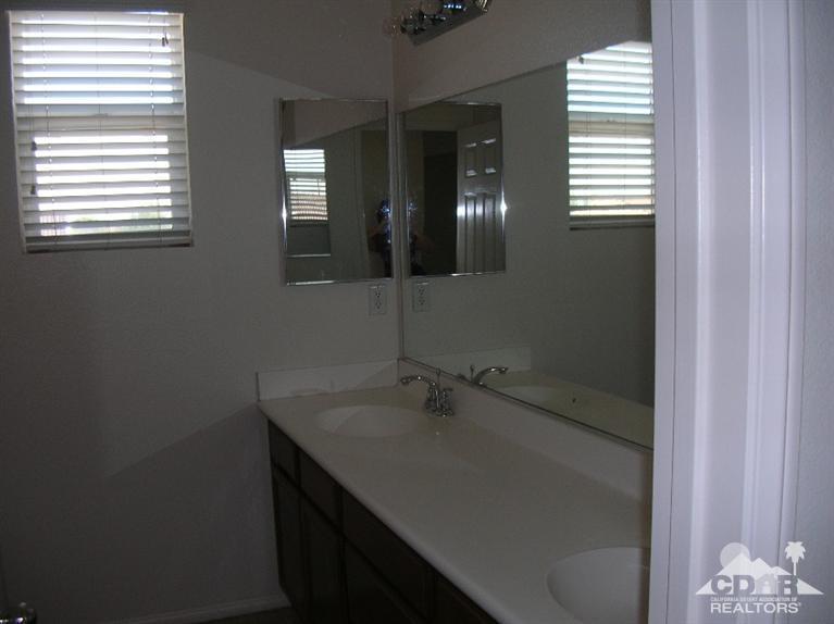 82797 Mount Riley Drive Indio, CA 92203 - Photo 12 of 17 a bathroom with a sink and a mirror