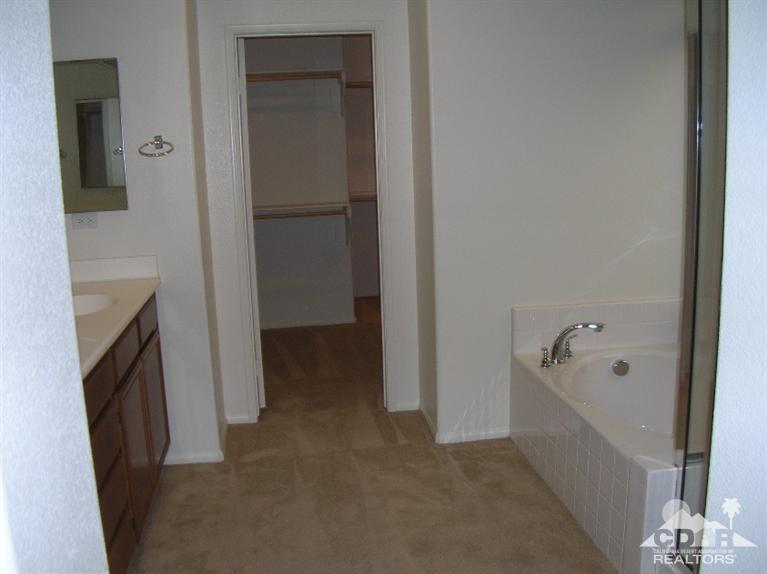 82797 Mount Riley Drive Indio, CA 92203 - Photo 7 of 17 a bathroom with a tub and a shower