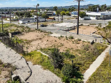 a view of a yard with wooden fence