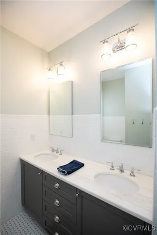 a bathroom with a toilet a sink and a mirror