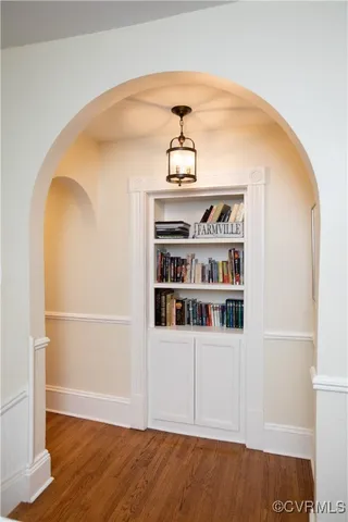 a view of a kitchen with a stove and white cabinets