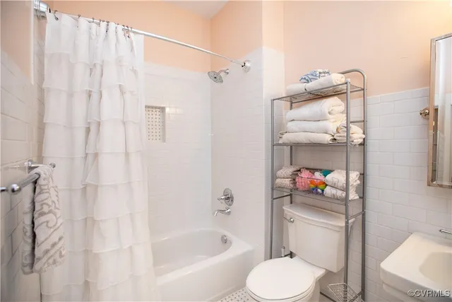 a bathroom with a double vanity sink a mirror and a bathtub