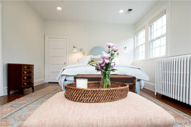 a bedroom with two beds and a chandelier