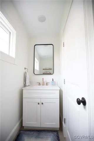 a front view of a house with a garden and trees