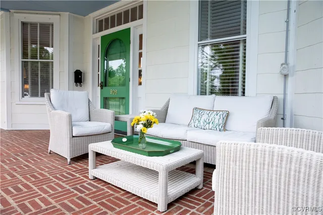 a living room with furniture a fireplace and a large window