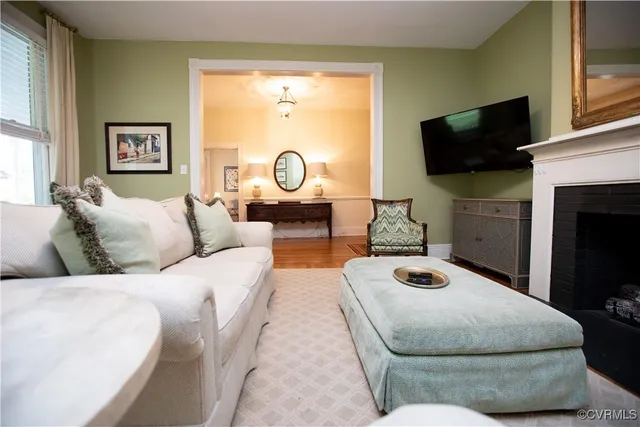 a living room with furniture a rug and a window