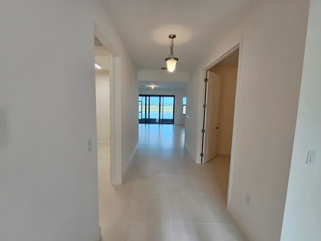 an empty room with wooden floor and mirror