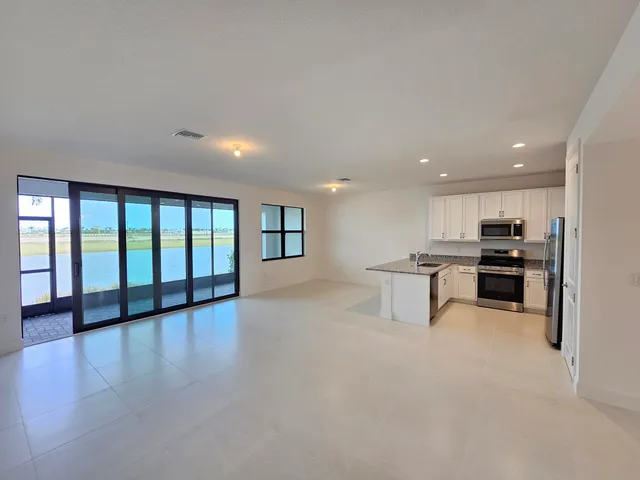 a view of a kitchen with a sink and a large window