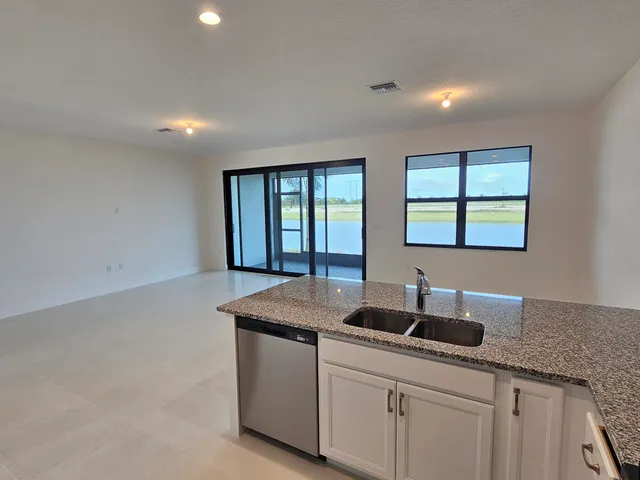a kitchen with a sink cabinets and window
