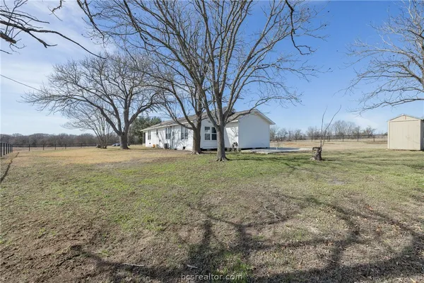 a house view with pool in front of house