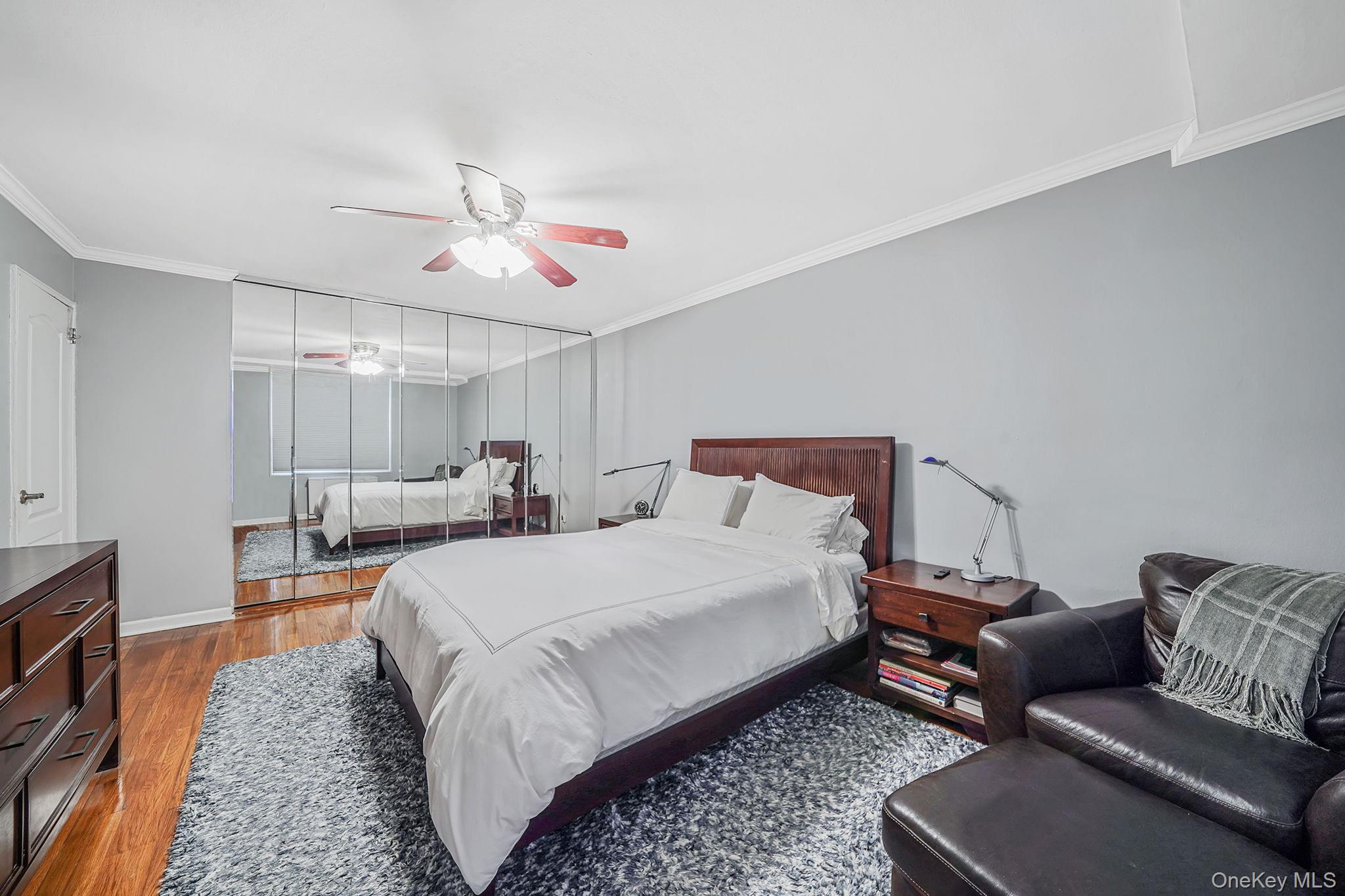 18-35 Corporal Kennedy Street, Unit 2B Queens, NY 11360 - Photo 11 of 25 a spacious bedroom with a bed couch and a window