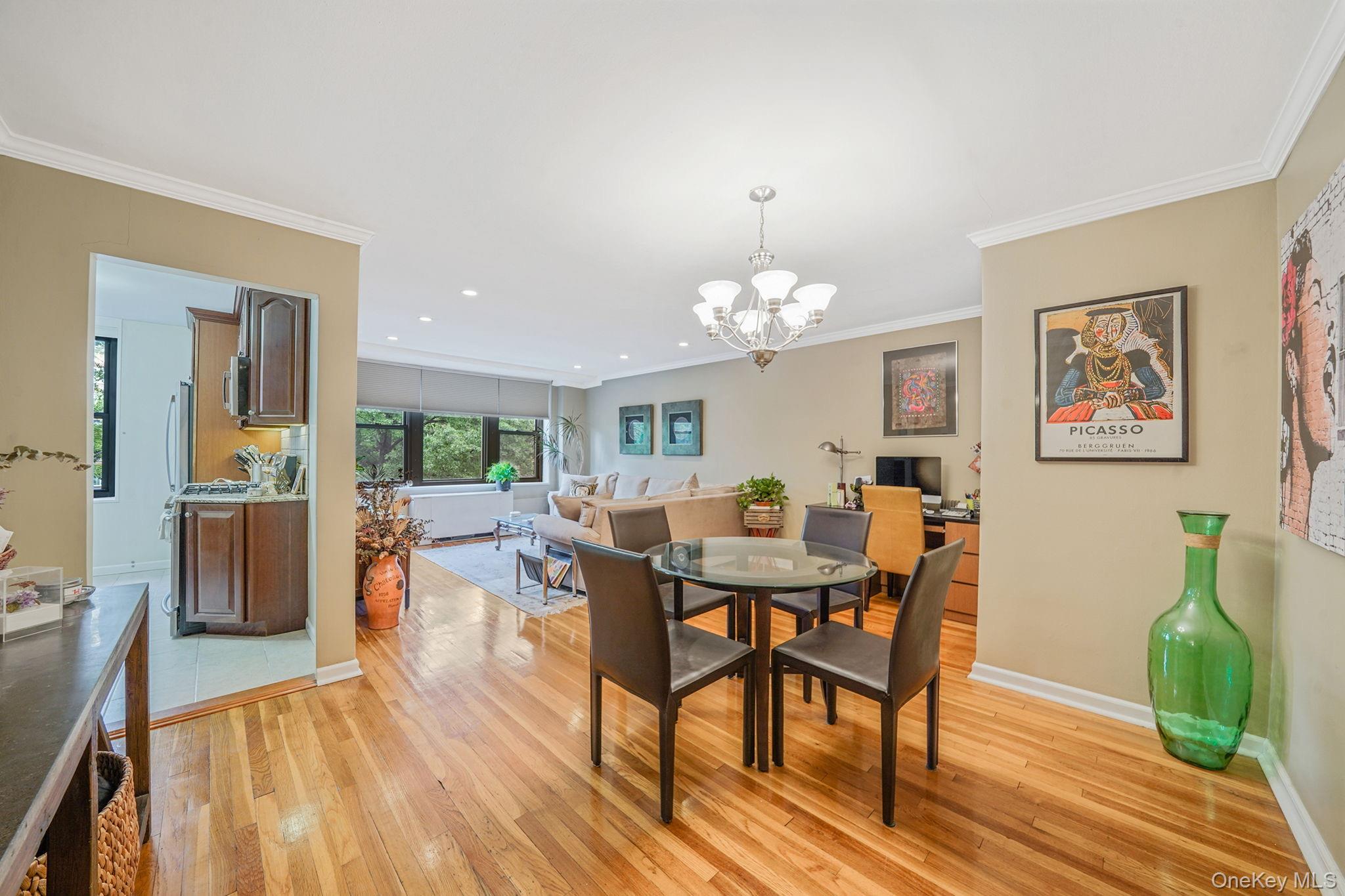 18-35 Corporal Kennedy Street, Unit 2B Queens, NY 11360 - Photo 23 of 25 a view of a dining room with furniture wooden floor and a chandelier