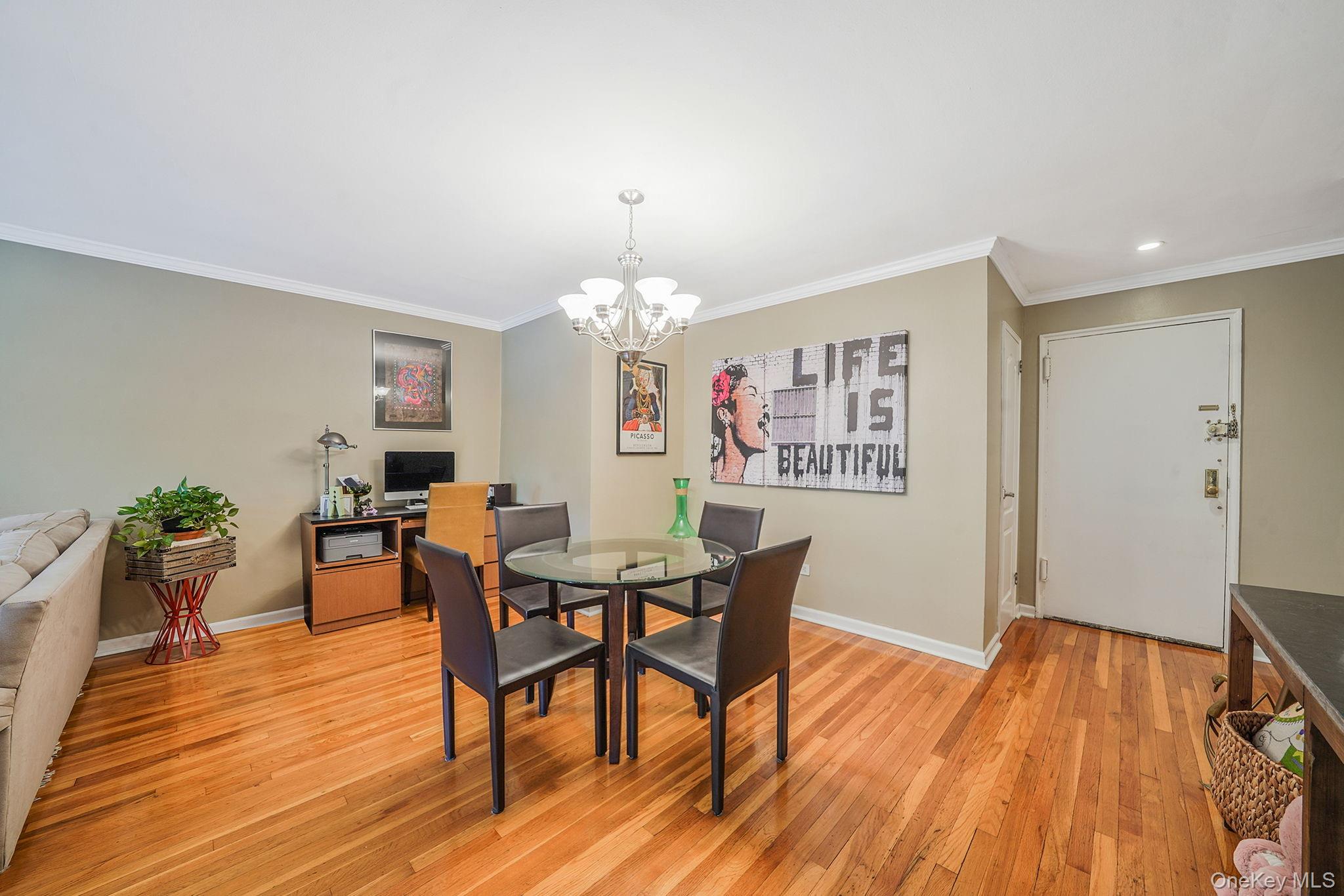 18-35 Corporal Kennedy Street, Unit 2B Queens, NY 11360 - Photo 3 of 25 a view of a dining room with furniture and wooden floor