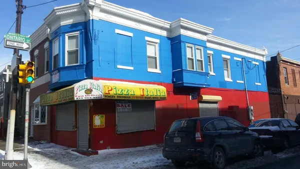 a front view of a building with parking