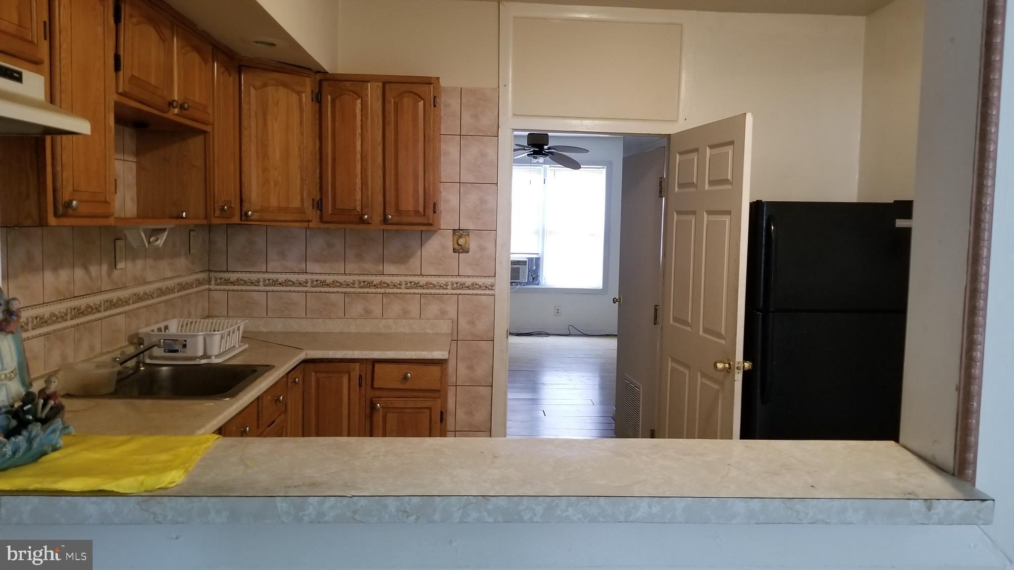 3401 North Front Street Philadelphia, PA 19140 - Photo 7 of 9 a kitchen with a refrigerator and a sink