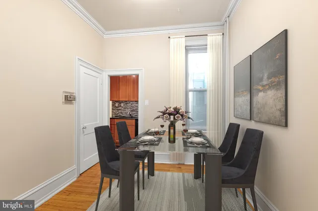 a view of a dining room with furniture and wooden floor
