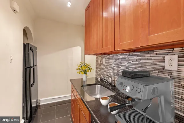 a kitchen with a stove a refrigerator and a sink