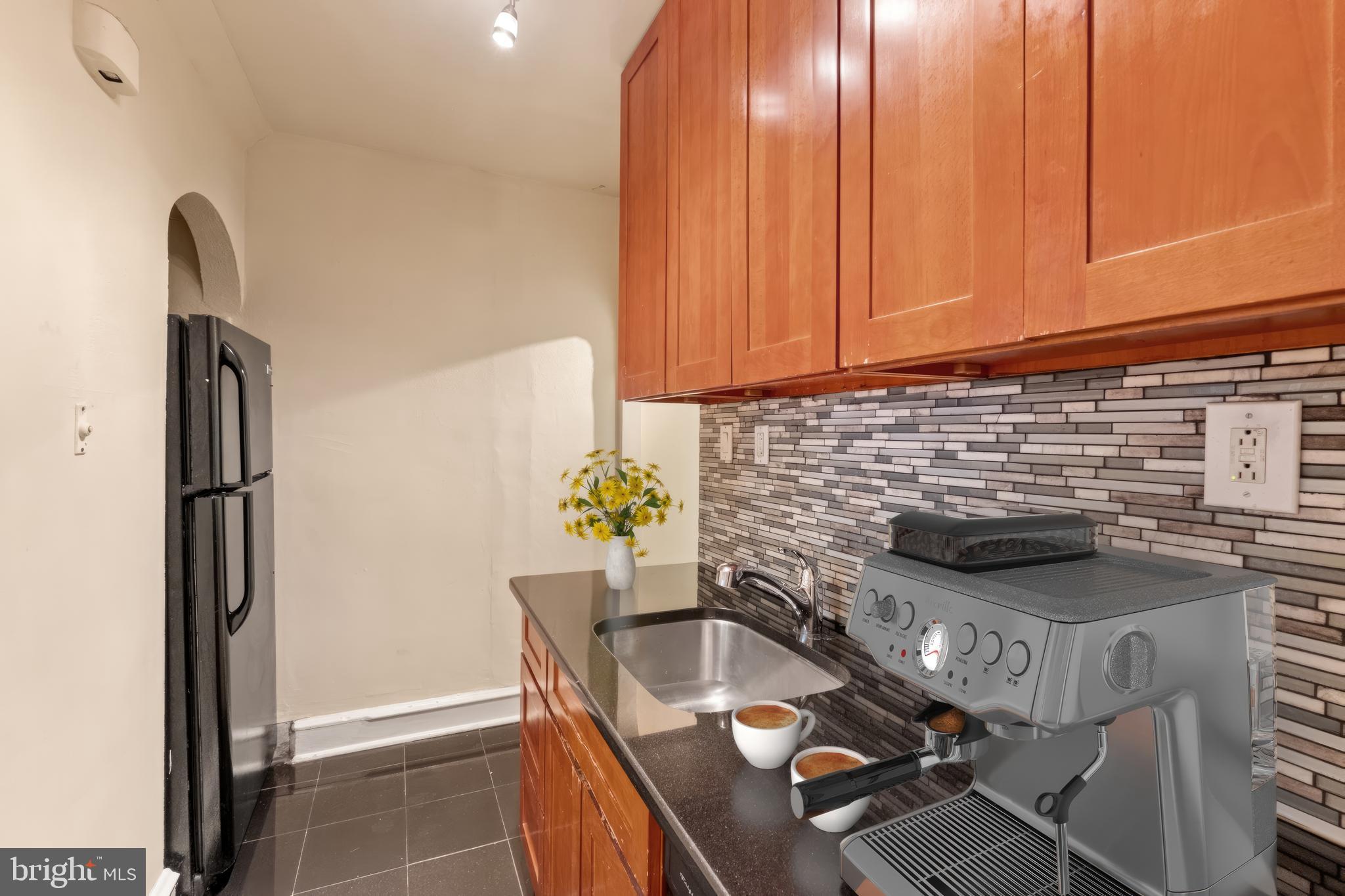 2433 Fairmount Avenue, Unit 1 Philadelphia, PA 19130 - Photo 4 of 13 a kitchen with a stove a refrigerator and a sink